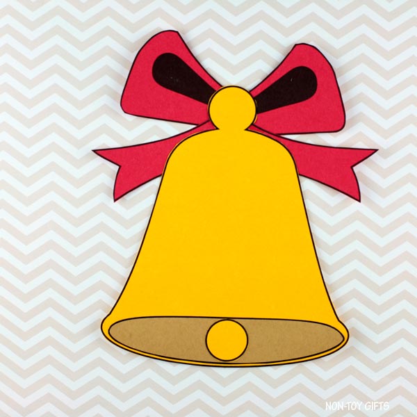 Christmas bell cut-and-paste activity showing bow, clapper, and bell shapes