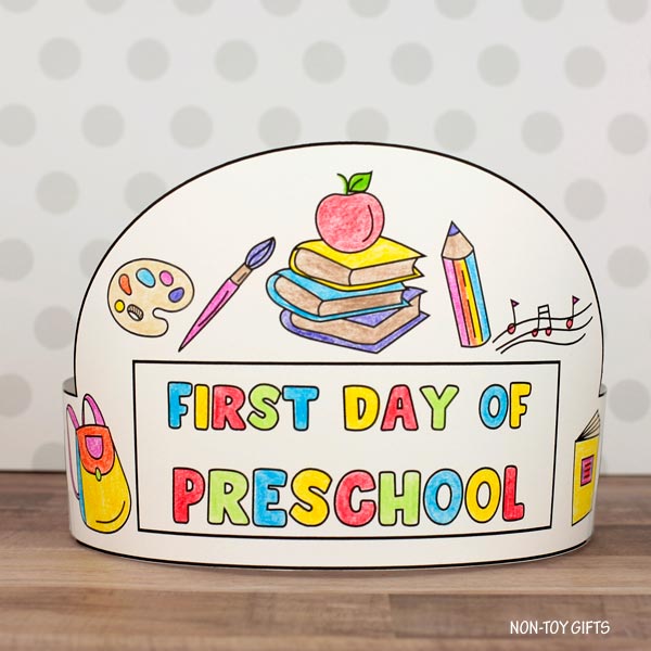 Printable first day of preschool paper hat craft with backpack, books, and apple coloring images