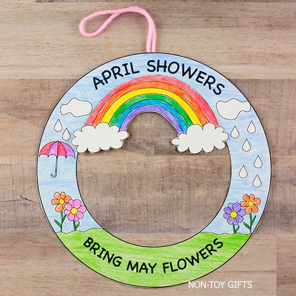 April Showers Bring May Flowers wreath printable with rainbow, flowers, and clouds spring craft for kids