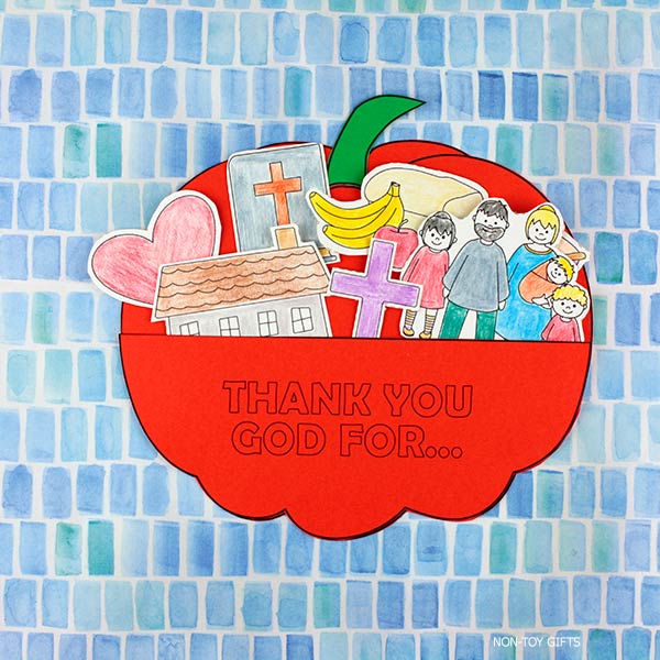 Printable Christian Thanksgiving pumpkin craft for kids – color, cut, and assemble a gratitude pumpkin pocket with blessings like family, Bible, and food.