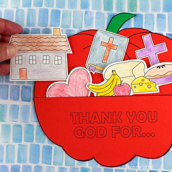 Faith-based Thanksgiving activity for preschool and homeschool – pumpkin pocket craft where children thank God for blessings through cut-out pieces.